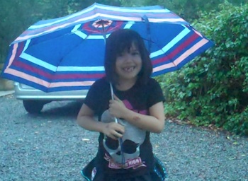 Amelia braves the rain to teach the French alphabet